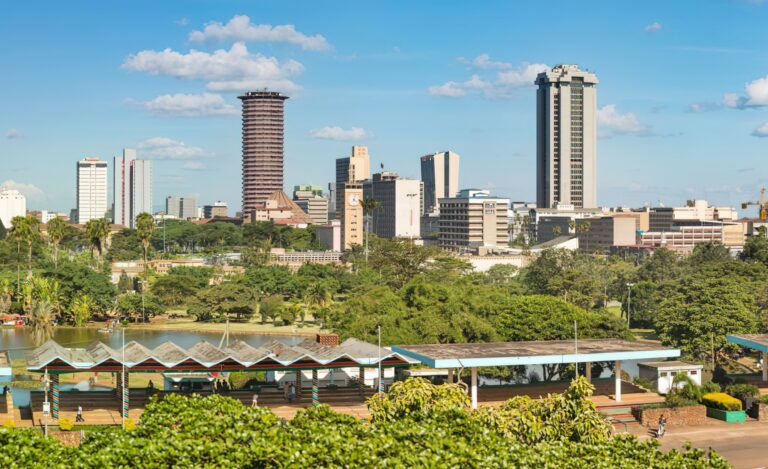 Skyline of Nairobi, Kenya with Uhuru Park in the foreground and a helicopter on top of the KICC