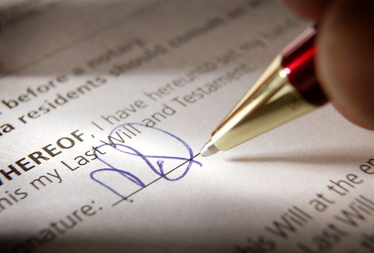 a hand signing a will