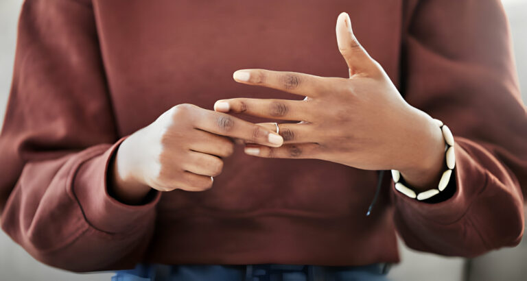 woman taking off her wedding ring during a divorce process
